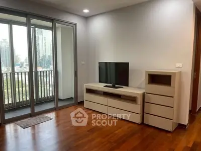 Modern living room with balcony view and sleek wooden flooring.