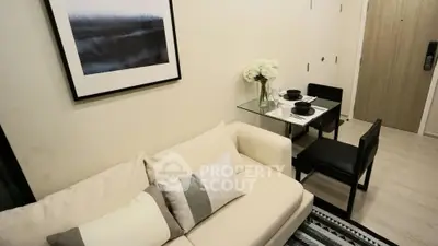 Modern living room with cozy sofa and elegant dining area in a stylish apartment.
