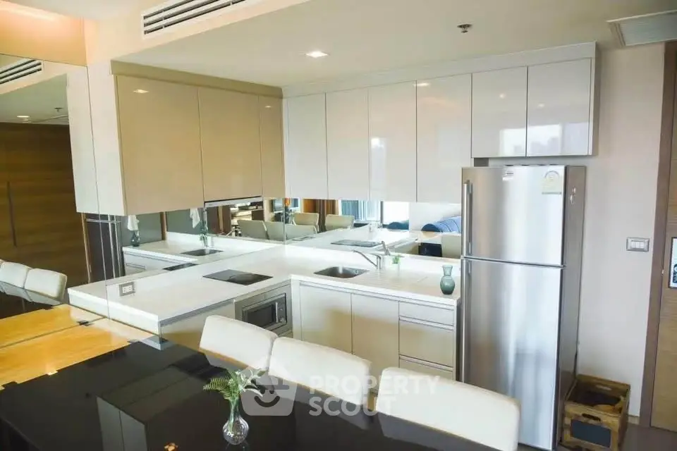 Modern kitchen with sleek cabinetry and stainless steel appliances in a stylish apartment.