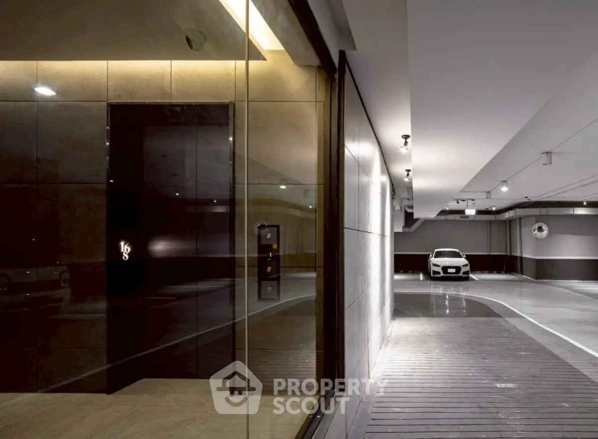 Modern parking garage with sleek design and luxury vehicle, showcasing premium real estate amenities.