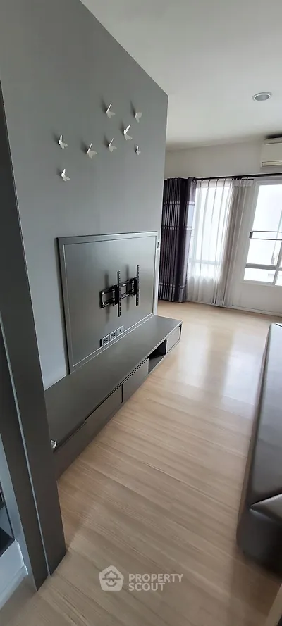 Modern living room with wall-mounted TV setup and stylish decor