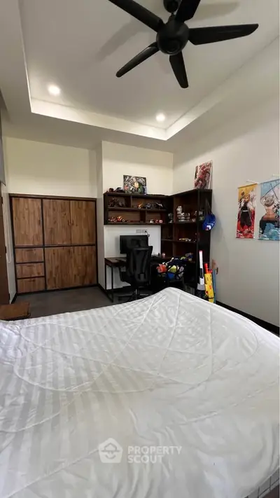 Spacious bedroom with modern decor and built-in storage, ideal for comfort and style.
