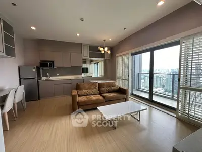 Modern open-plan living room with city view and balcony access