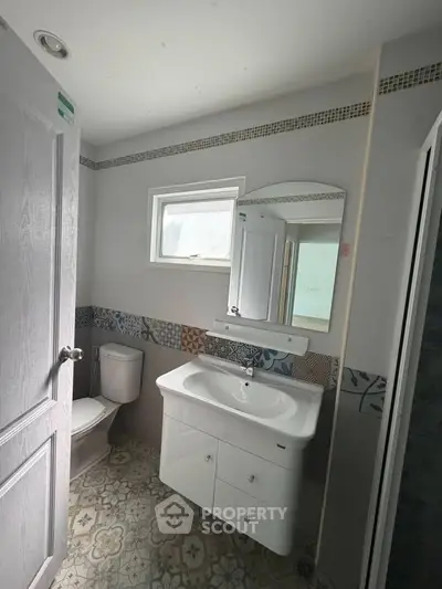 Charming bathroom with modern fixtures and stylish tile design, perfect for a cozy home.