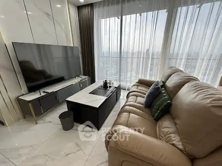 Luxurious living room with modern decor and stunning city view.