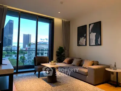 Modern living room with city view, stylish decor, and large windows in a high-rise apartment.