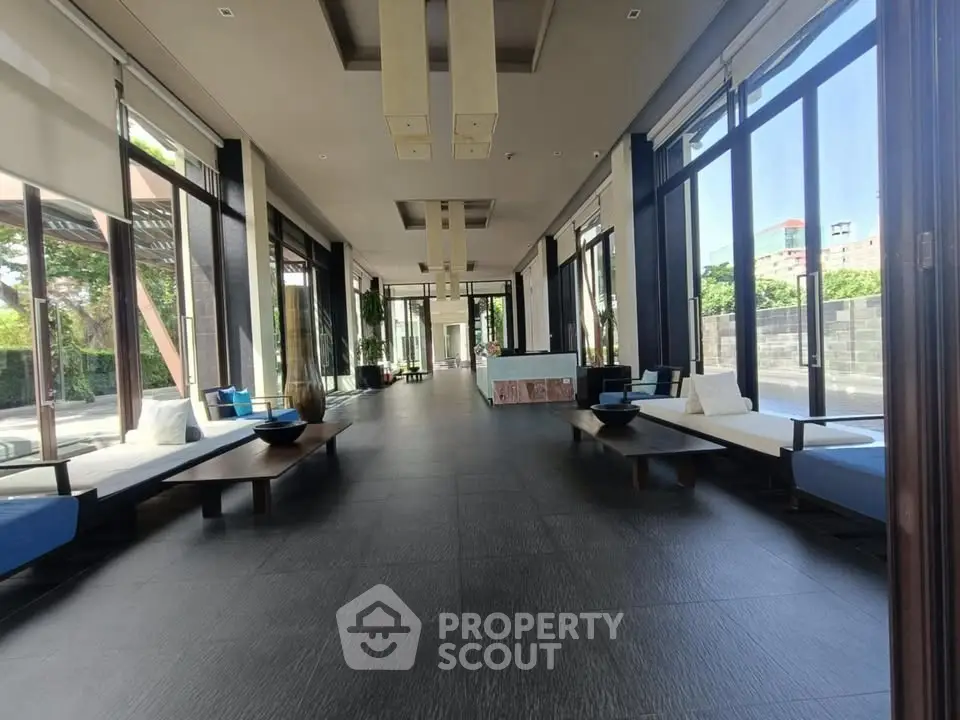 Spacious modern living area with floor-to-ceiling windows and stylish seating