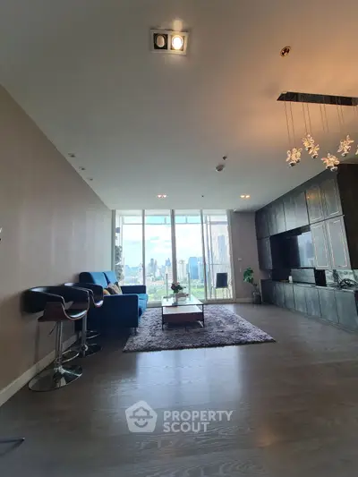 Spacious modern living room with city view, sleek furniture, and elegant lighting.
