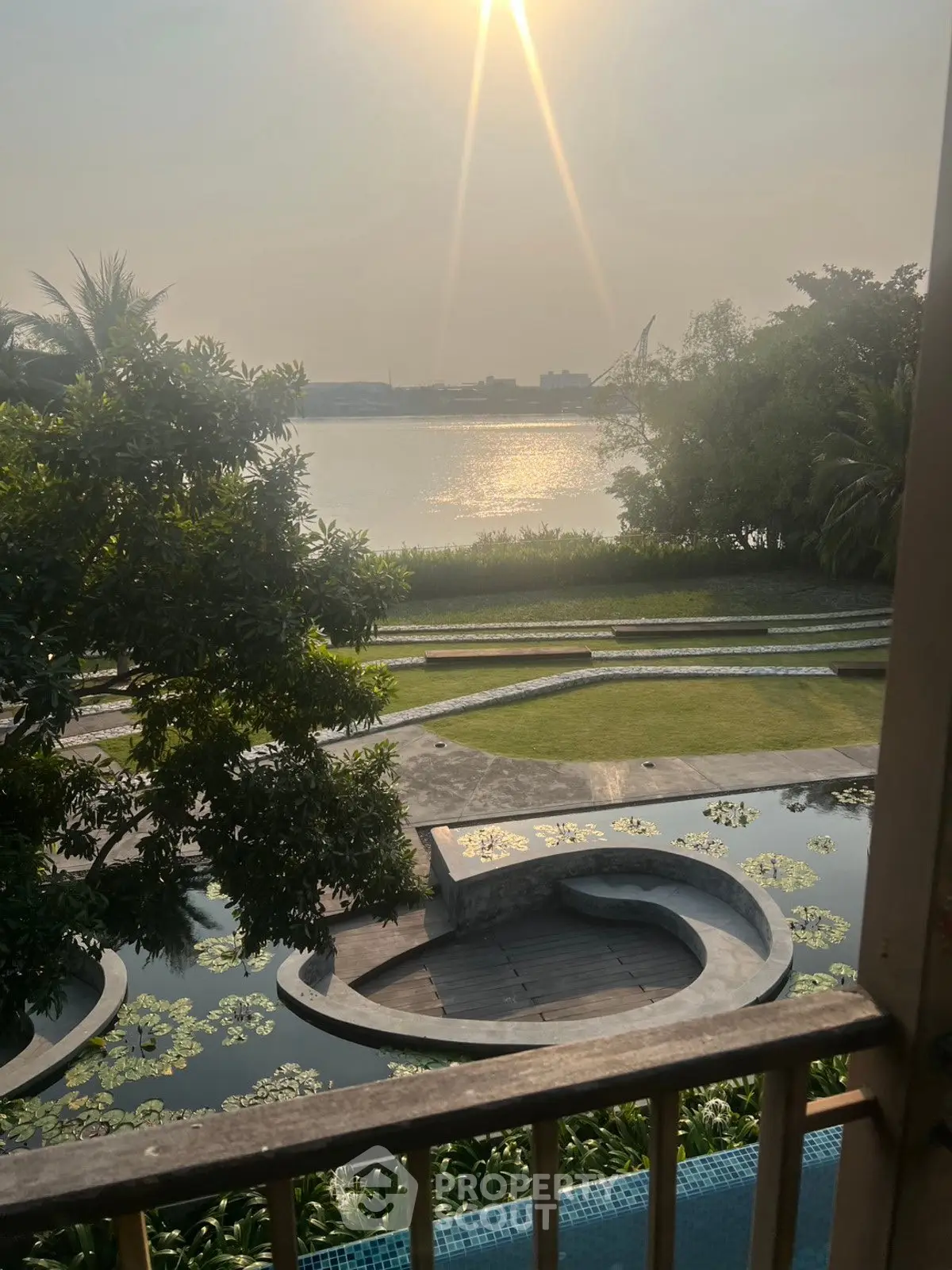 Stunning waterfront view with lush greenery and serene ambiance, perfect for luxury living.