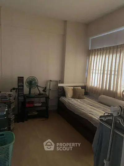 Cozy bedroom with natural light and minimalist decor, perfect for relaxation and comfort.