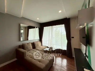 Modern living room with cozy sectional sofa and large window for natural light.