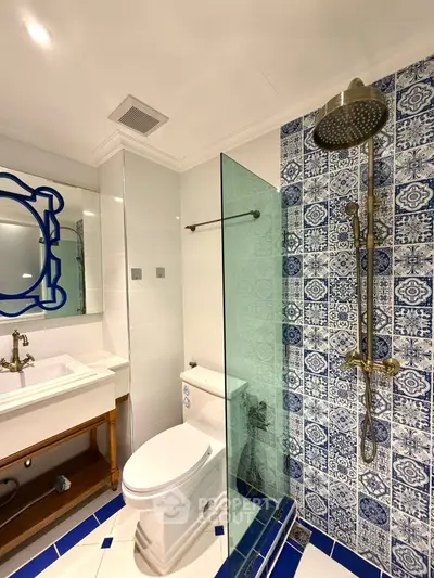 Elegant bathroom with blue patterned tiles and modern fixtures