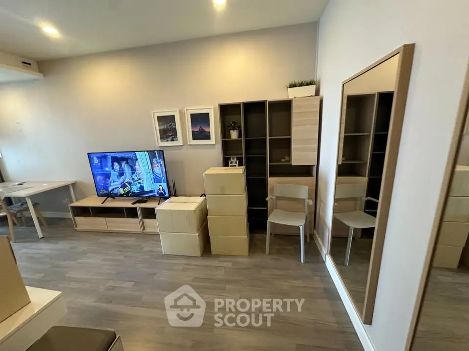Modern living room with stylish furniture and wall-mounted TV, perfect for relaxation and entertainment.