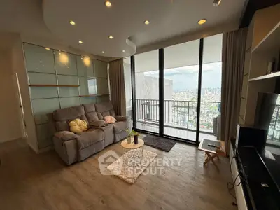 Spacious living room with city view and modern decor in high-rise apartment