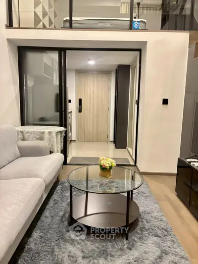 Modern living room with stylish decor and cozy ambiance in a contemporary apartment.