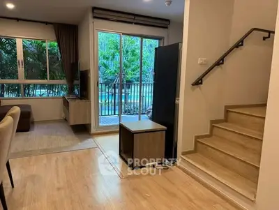 Modern living room with pool view and stylish staircase