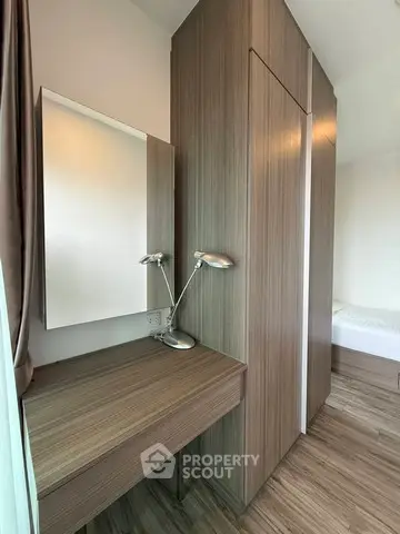 Modern bedroom with sleek wooden wardrobe and stylish desk lamp