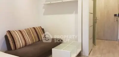 Cozy small living room with modern sofa and sleek coffee table in minimalist design.