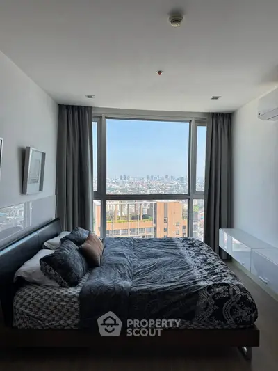 Spacious bedroom with stunning city view and modern decor