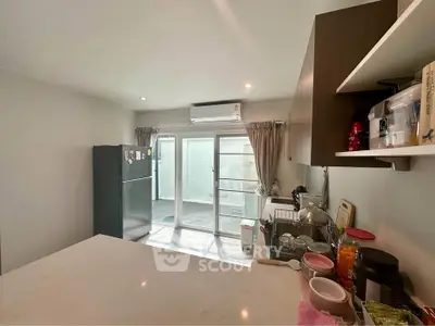 Modern kitchen with sleek appliances and ample natural light, featuring a spacious layout and stylish cabinetry.