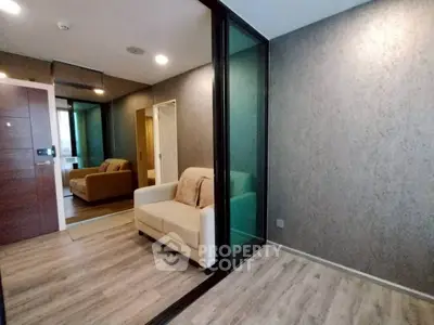 Modern living room with glass partition and cozy seating area