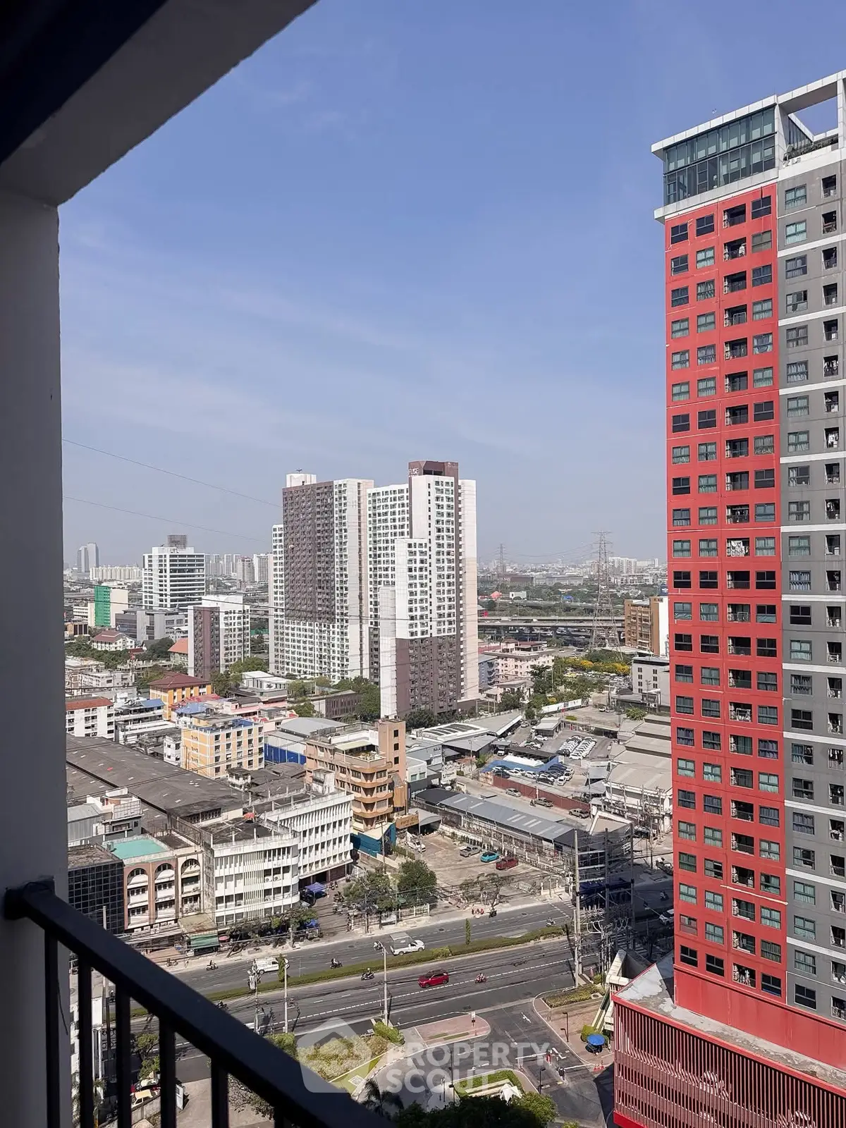 Stunning urban cityscape view from a high-rise balcony, showcasing modern architecture and vibrant city life.