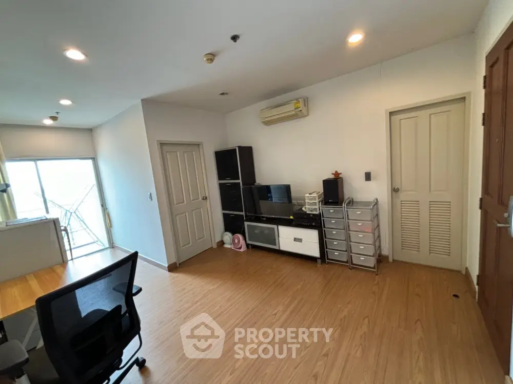 Spacious modern living room with wooden flooring and ample natural light