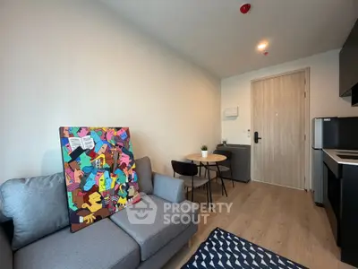 Modern living room with stylish decor and compact dining area