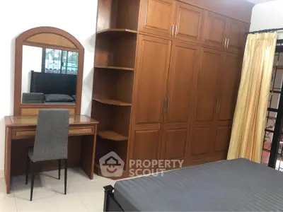 Spacious bedroom with built-in wardrobe and elegant vanity desk