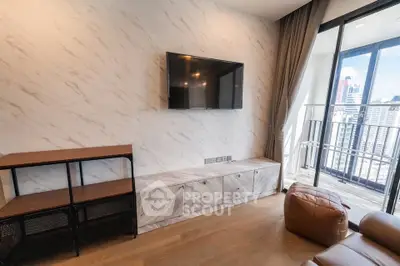 Modern living room with wall-mounted TV and city view balcony in luxury apartment.