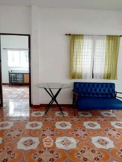 Charming living area with vintage tiles and cozy seating, perfect for relaxation.