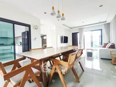 Spacious modern dining area with wooden furniture and open layout kitchen in a bright apartment.