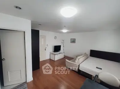 Spacious living room with modern decor and wooden flooring