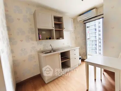 Charming kitchen with open layout and city view, featuring modern cabinetry and natural light.