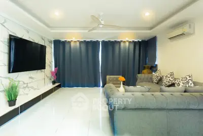 Spacious modern living room with elegant decor and large TV