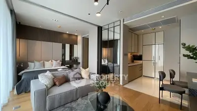 Luxurious open-plan living room with modern kitchen and elegant bedroom in a stylish apartment.