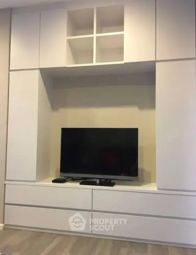 Modern living room with sleek built-in TV cabinet and storage