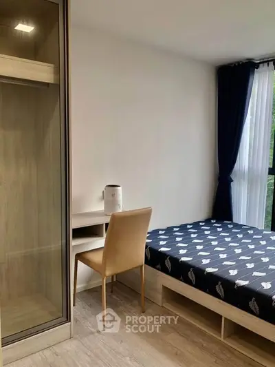 Modern bedroom with stylish decor, featuring a comfortable bed, sleek wardrobe, and elegant curtains.