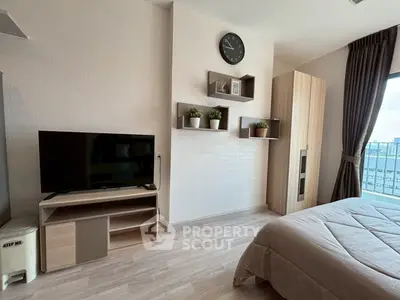 Modern bedroom with TV, stylish shelves, and large window view.