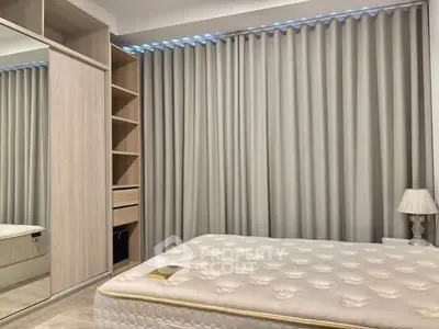 Modern bedroom with elegant curtains and spacious wardrobe