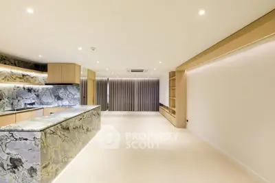 Luxurious open-plan kitchen with marble countertops and modern lighting