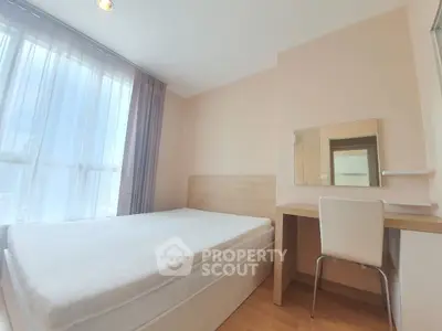 Bright and cozy bedroom with natural light and modern furnishings.
