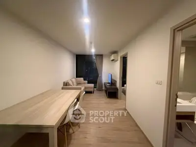 Modern living room with cozy sofa and dining area in a stylish apartment.