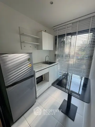Modern kitchen with sleek appliances and natural light, perfect for urban living.