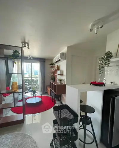 Modern living room with stylish decor and open layout, featuring a cozy seating area and natural light.