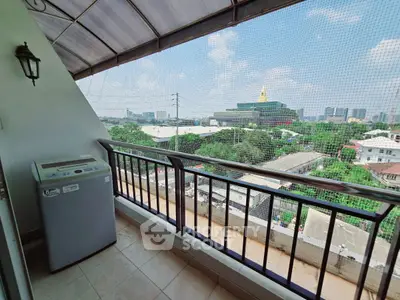 Charming balcony with city view and washing machine, perfect for urban living.