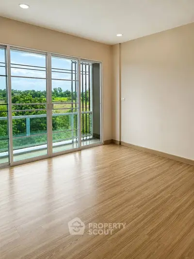 Spacious empty room with large windows and scenic view, perfect for customization.