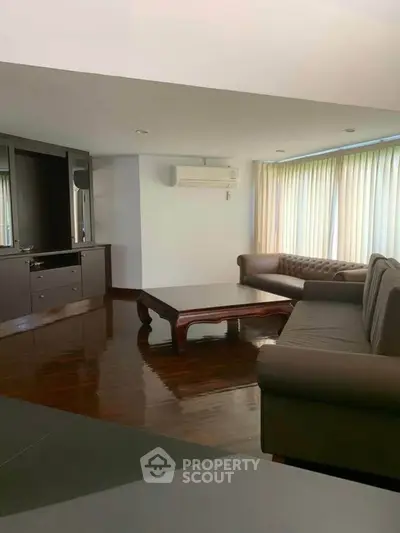 Spacious living room with elegant sofas and natural light