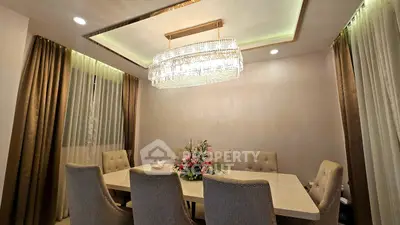 Elegant dining room with luxurious chandelier and plush seating
