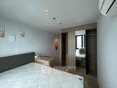 Modern bedroom with stylish wooden wardrobe and large window view